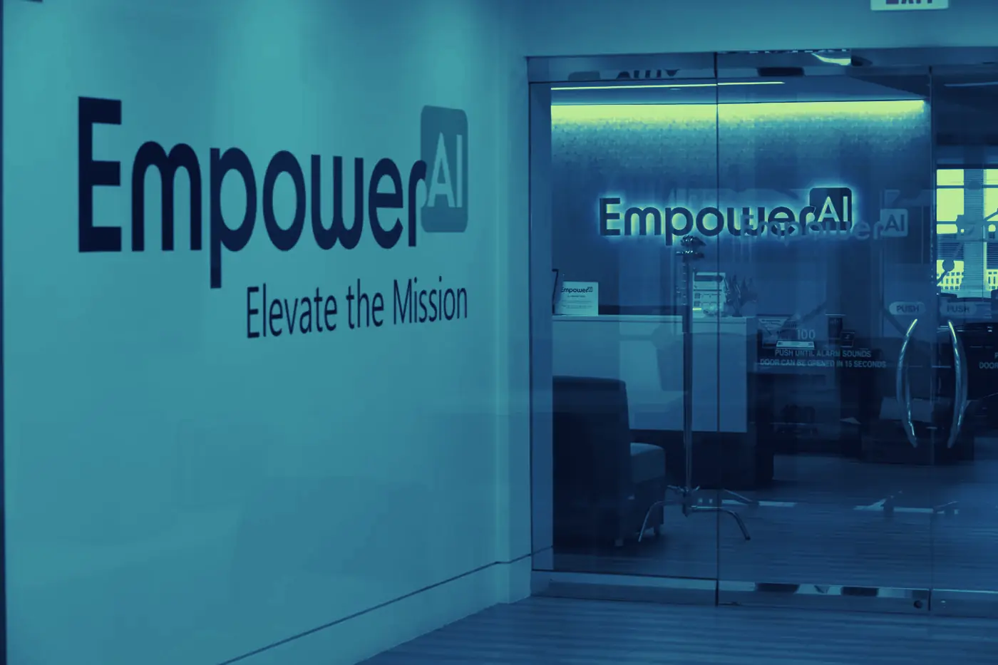 The Empower AI office entrance, with the logo on the wall and the lit reception area behind glass doors